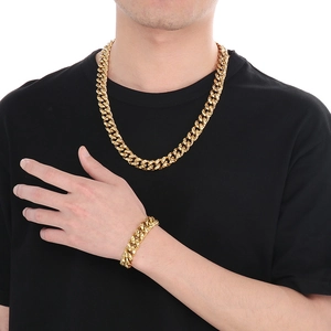 Detail of gold hammered cuban link chain necklace and bracelet set on male model