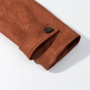 Detail of caramel faux suede sleeve cuff featuring a dark button and neat stitching