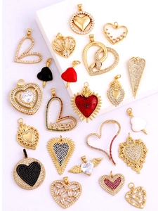 Flat lay of heart-shaped gold-plated pendants with cubic zirconia for DIY jewelry making