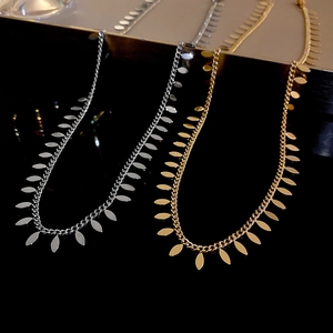 Metallic leaf sequin tassel choker necklaces in gold and silver finishes on black display