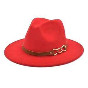 Detail of red fedora hat with brown leather band and golden triple-ring metal buckle