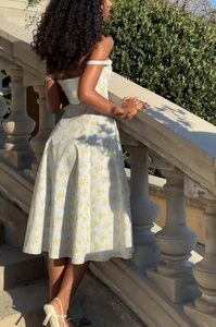 Detail of floral print summer dress with off-shoulder neckline and side slit
