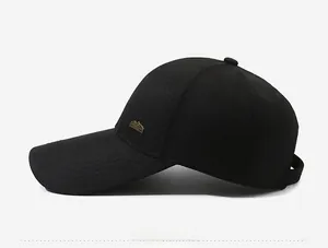 Detail view of the black baseball cap showing the mountain metal logo on the side