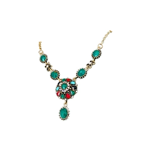 Vintage floral necklace with colorful crystals and green gemstone on a white background