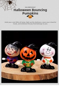 Close-up of Halloween wind-up jumping toys featuring pumpkin, ghost, and witch on wood
