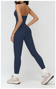 Detail of dark blue backless yoga set featuring high-waist leggings and halter sports bra