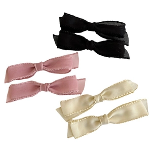 Set of 6 satin ribbon bow hair clips in black, pink and cream white on a white background