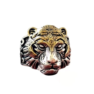 Detailed view of vintage tiger head ring with dual-tone silver and gold plated relief