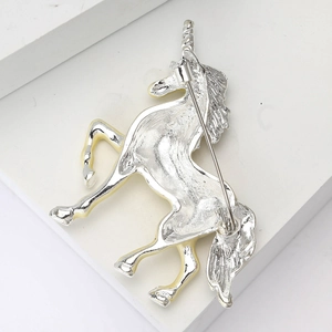 Detail view of the silver unicorn brooch back showing pin clasp and high polish finish