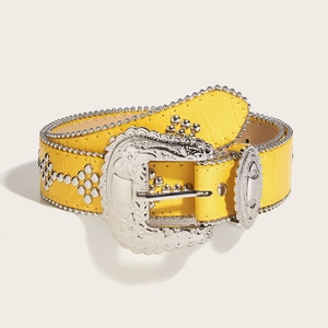 Detail of yellow crocodile embossed leather belt with silver studs and western buckle