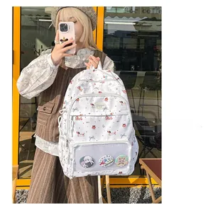Detailed view of white cartoon printed backpack featuring clear mesh window and badges
