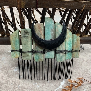 Macro detail of handmade moon hair comb with raw aquamarine crystals and black wire