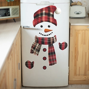 Detailed view of snowman fridge stickers with red plaid scarf on a white kitchen appliance