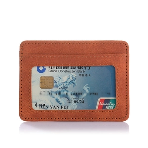 Detailed close-up of brown PU leather passport holder with clear ID slot and fine stitching