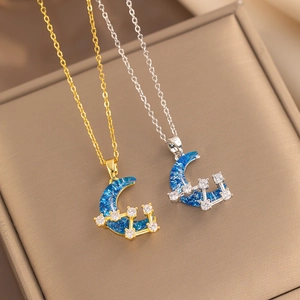 Star and moon opal necklaces in gold and silver finish on a jewelry box display