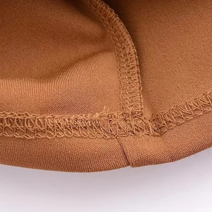Detailed close-up of brown cowl neck dress fabric showing neat stitching and texture