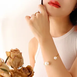 Elegant 18K gold plated pearl bangle and ring set worn by model for vintage style