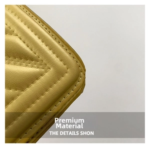 Detailed close-up of yellow quilted leather bag featuring high-quality V-shaped stitching