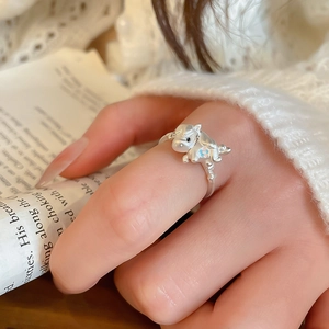 Close-up of silver open ring featuring a 3D dragon design and light blue floral detail