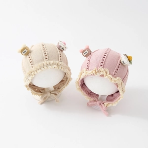 Knit baby hat with bear ears and lace trim in cream and dusty rose pink colors