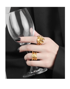 Close-up of minimalist gold plated rings with irregular 3D texture on model hand
