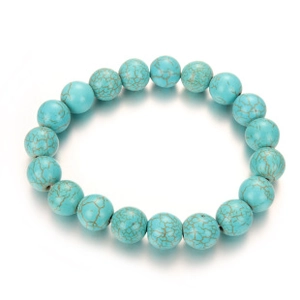 Detail of blue turquoise bead bracelet with golden crackle patterns and reflective shadow