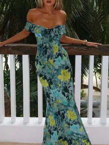 Detail of floral print off-the-shoulder dress with ruffled neckline and fishtail hemline