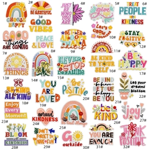 Set of 32 colorful embroidered patches with rainbow, floral, and positive quote patterns