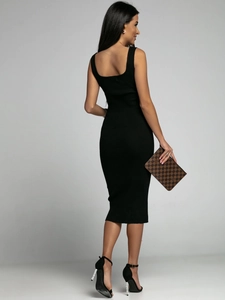 Detail of a black sleeveless ribbed knit dress showing the scoop back and slim fit silhouette