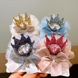 Detail of glitter crown hair clips with lace mesh, satin bows and star rhinestone pendants