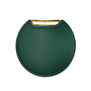 Emerald green round standing cutting board with golden handle and garlic grinding area
