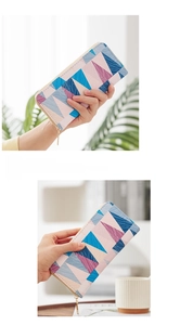 Close-up of a long zipper wallet with colorful geometric pattern in a lifestyle setting