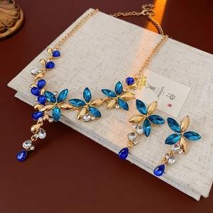 Detail of vintage flower jewelry set with blue rhinestones and water drop pendants