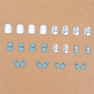 Short square press-on nails with blue sunset bird silhouettes and white branch designs