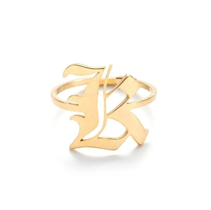 Detailed macro view of a vintage gold open ring featuring a gothic Old English letter K