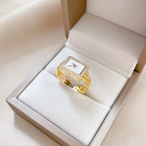Adjustable gold watch-shaped ring with rectangle zircon bezel on soft velvet background