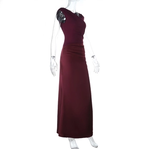Detail view of the elegant wine red sleeveless dress with waist pleats and side draping