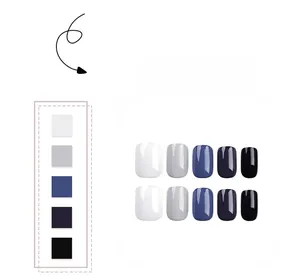 Short press-on nails in a gradient palette of white, grey, blue, purple, and black tones