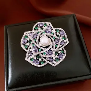 Vintage zircon pearl flower brooch with purple gemstones on black jewelry box