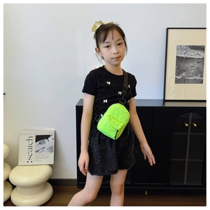 Close-up of a neon green nylon mini crossbody chest bag with adjustable black strap