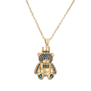 Detailed close-up of a golden teddy bear pendant necklace with blue zircon crown and limbs