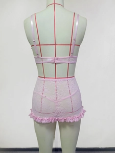 Detailed back view of pink lace lingerie set with ruffled edges on a tailor mannequin