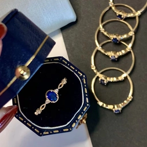 Elegant gold oval blue sapphire ring set with lace hollow design in a vintage box