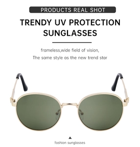 Detail of vintage round gold frame sunglasses with dark green lenses and UV protection
