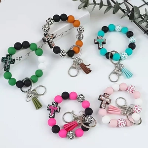Silicone bead keychains with leopard print crosses and tassels in assorted colors