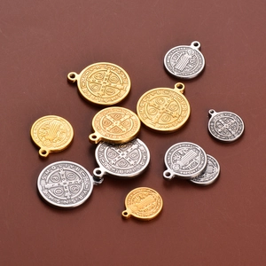 Detailed relief of Saint Benedict religious charms in gold and silver stainless steel