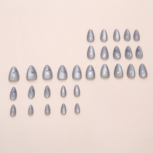 Deep grey cat eye press-on nails with minimalist blue bow designs and almond shape