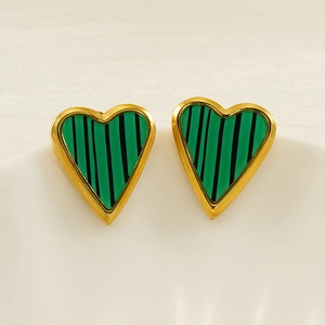 Detailed view of heart-shaped gold stud earrings with green malachite striped inlay