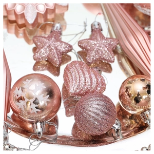 Macro view of rose gold Christmas ornaments with glitter sequins and snowflake textures