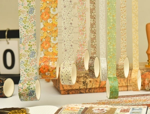 Close-up of vintage floral washi tape rolls for DIY journals and gift wrapping decoration